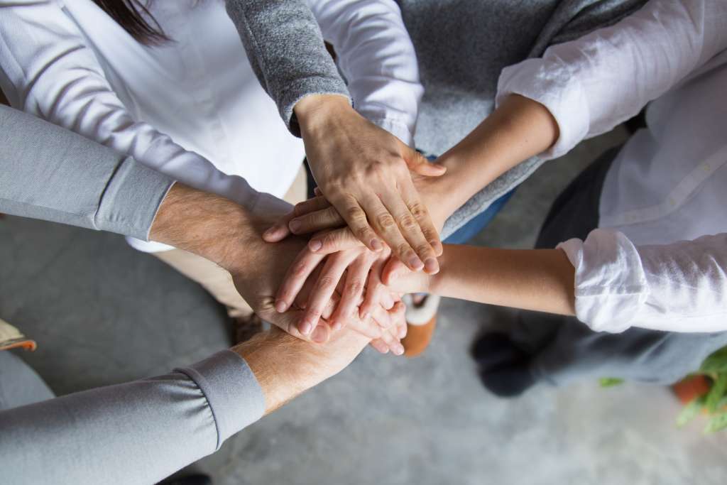 four team members expressing togetherness